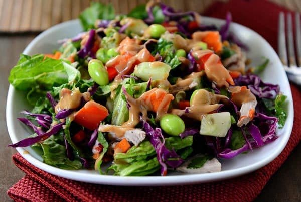 A white plate with a colorful chopped Thai salad. 