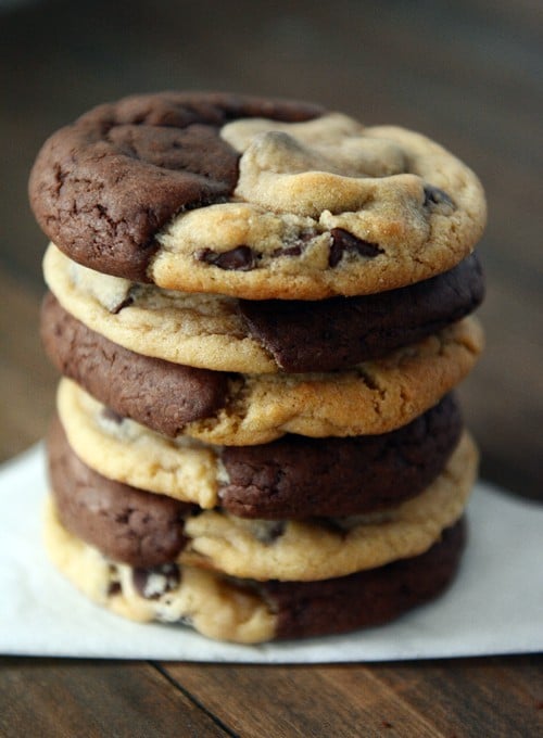 A stack of half brownie, half chocolate chip cookie cookies. 