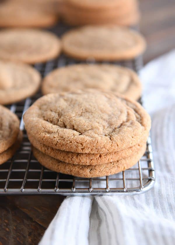 Stack of three soft and chewy ginger molasses cookies on cooling rack.