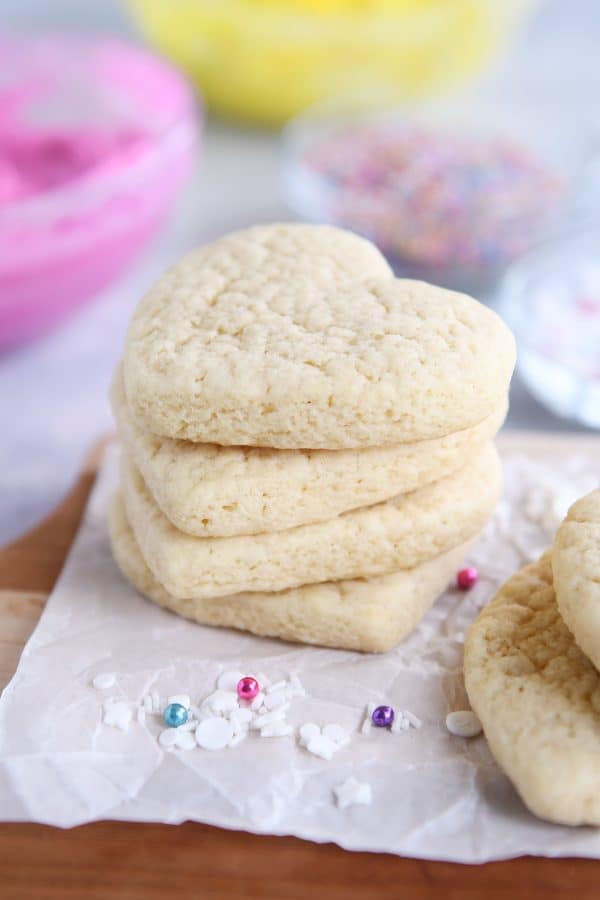 Four heart shaped sugar cookies stacked on each other.