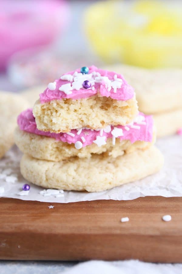 Pink frosted heart shaped sugar cookie broken in half.