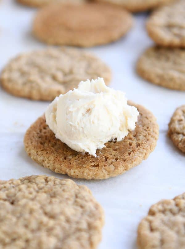 Oatmeal cookie with dollop of vanilla frosting on top.