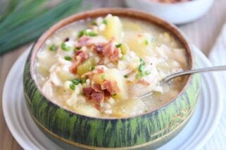 Green bowl filled with pressure cooker chicken corn chowder with bacon on top and spoon in the side.