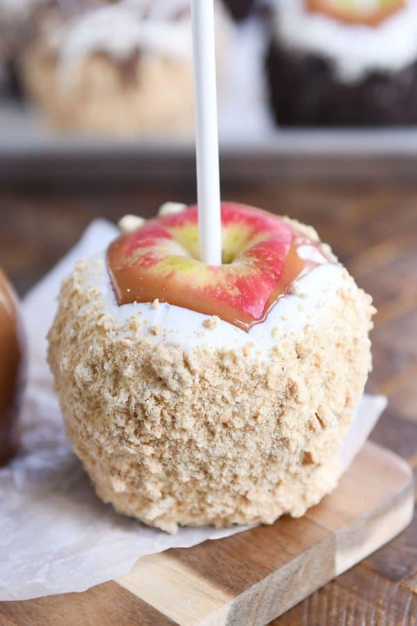 Honey crisp apple dipped in caramel and decorated with white chocolate and graham cracker crumbs.
