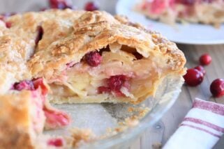 Slice cut out of apple cranberry pie.