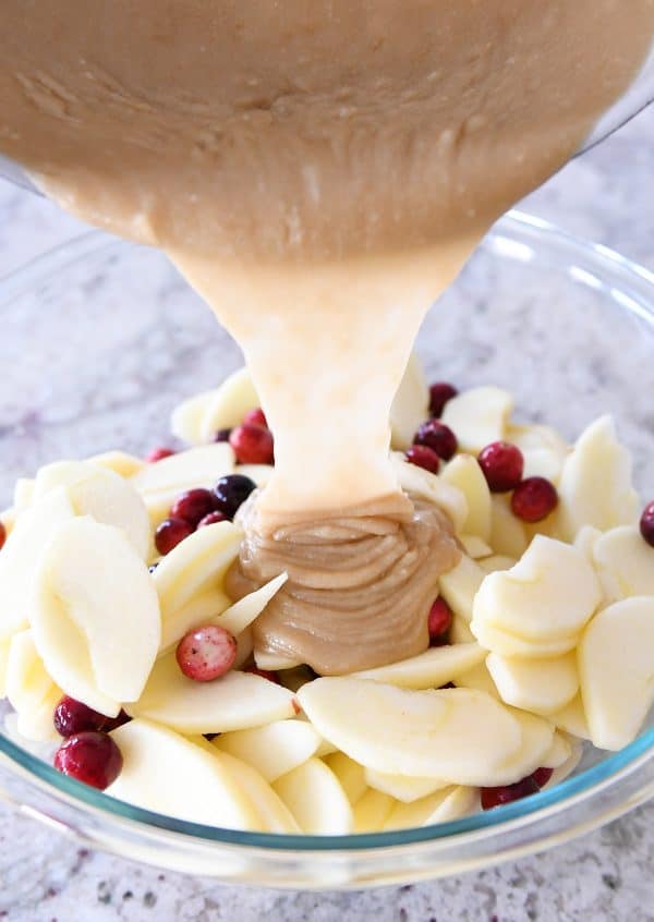 Pouring caramel sauce over cranberry apple pie