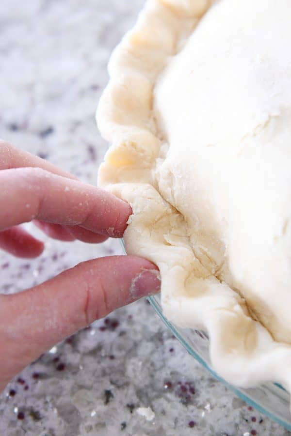 Crimping edges of double pie crust.