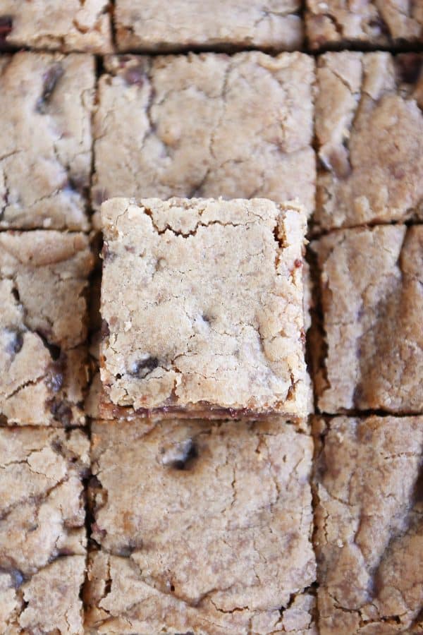 Top down view of pan of cut malted chocolate chip blondie squares.