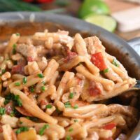 Scooping out spoonful of skillet chicken fajita pasta.