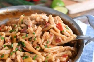 Scooping out spoonful of skillet chicken fajita pasta.