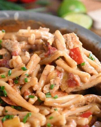 Scooping out spoonful of skillet chicken fajita pasta.
