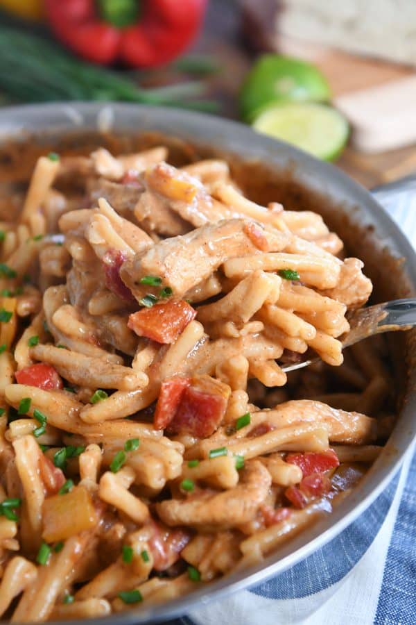 Scooping out spoonful of skillet chicken fajita pasta.