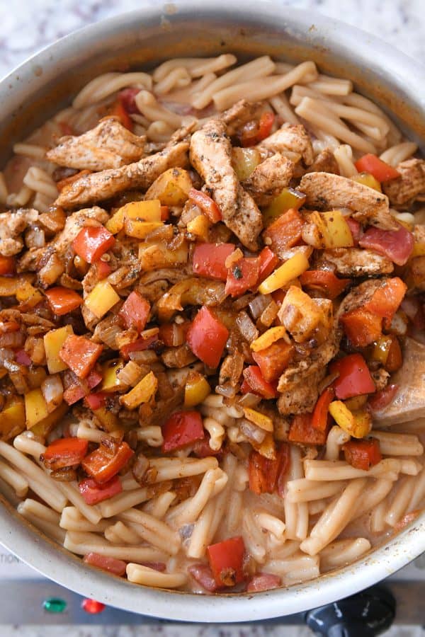 Combining skillet chicken fajita pasta.