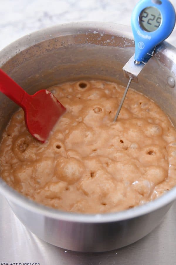 Bubbling caramel in a metal pot.
