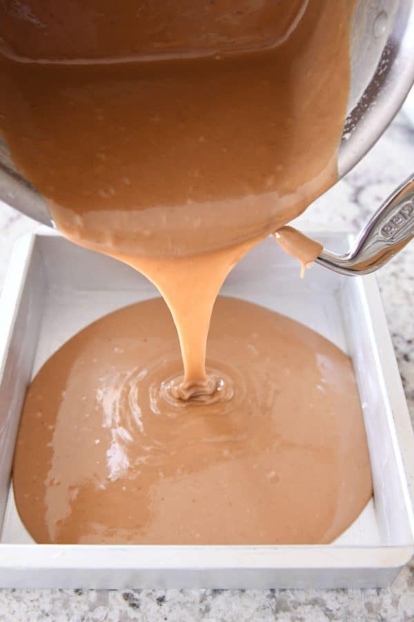 Caramel being poured into a metal pan.