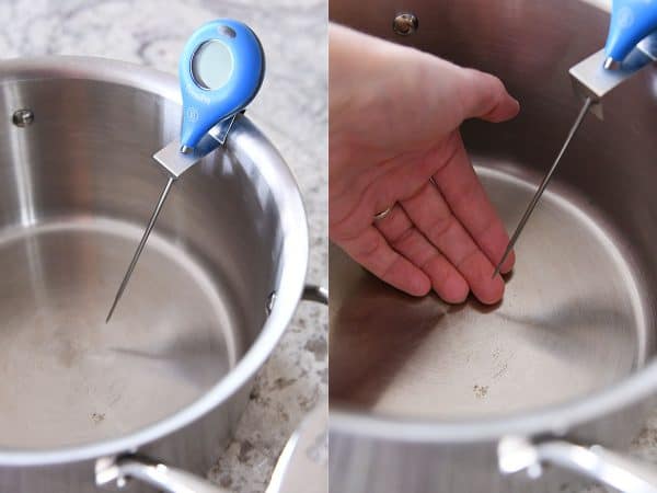 Candy thermometer clipped to side of heavy bottomed pan