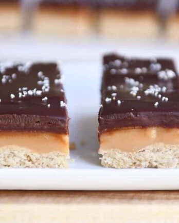 Two homemade grown up Twix bars on white tray.
