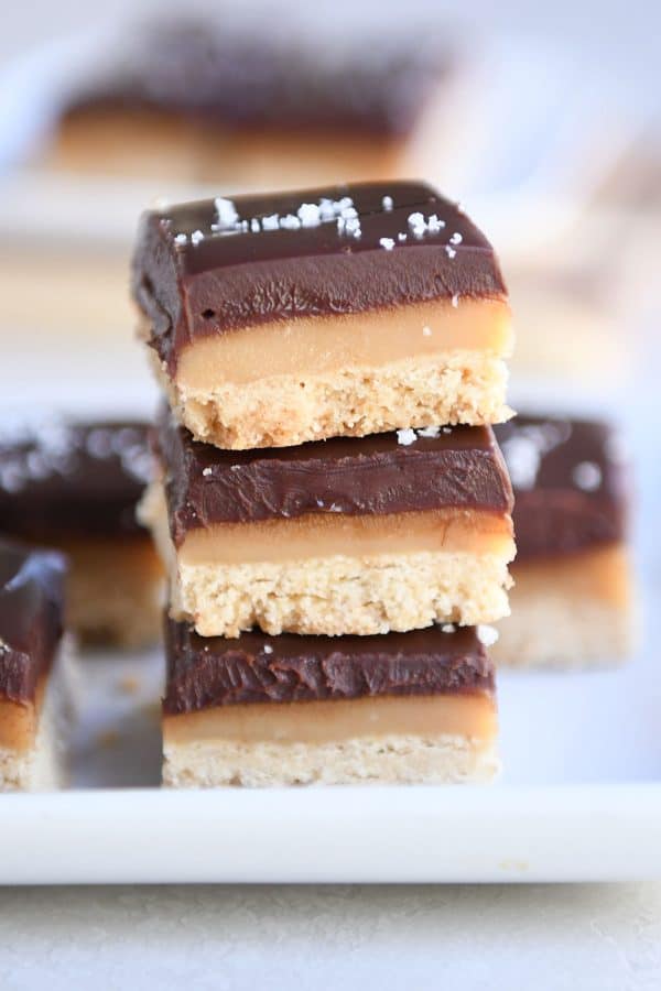 Three homemade grown up Twix bars stacked on each other.