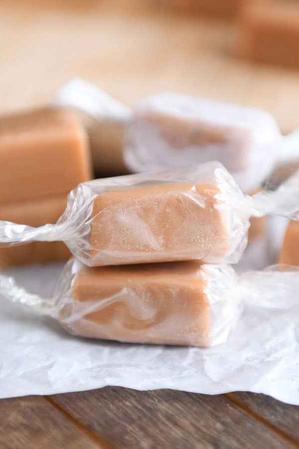 Wrapped homemade caramels stacked on each other.