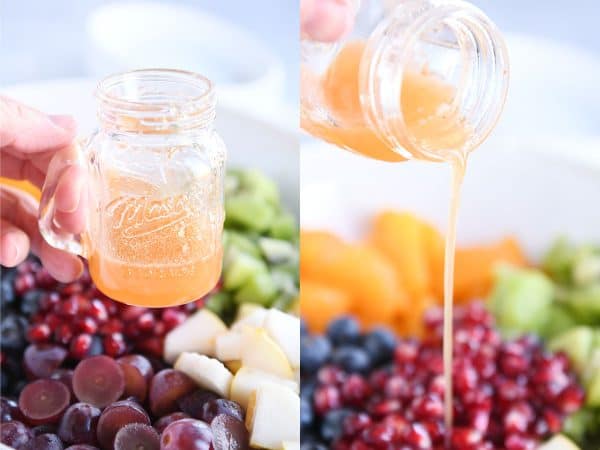 Pouring dressing over fruit in white bowl.