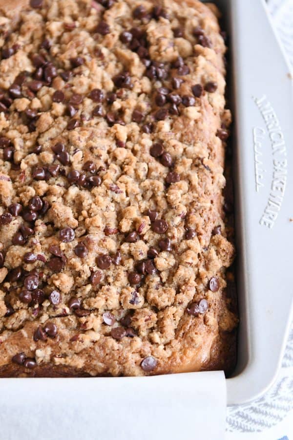 Top down view of baked banana cream cheese coffee cake with chocolate chip streusel.