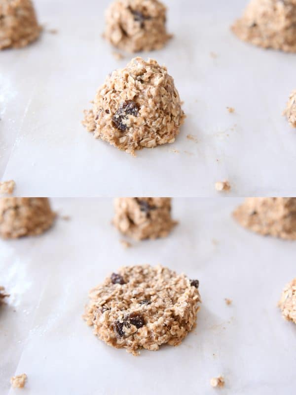 Oat cookie dough balls on a cookie sheet with one dough ball smashed before baking.