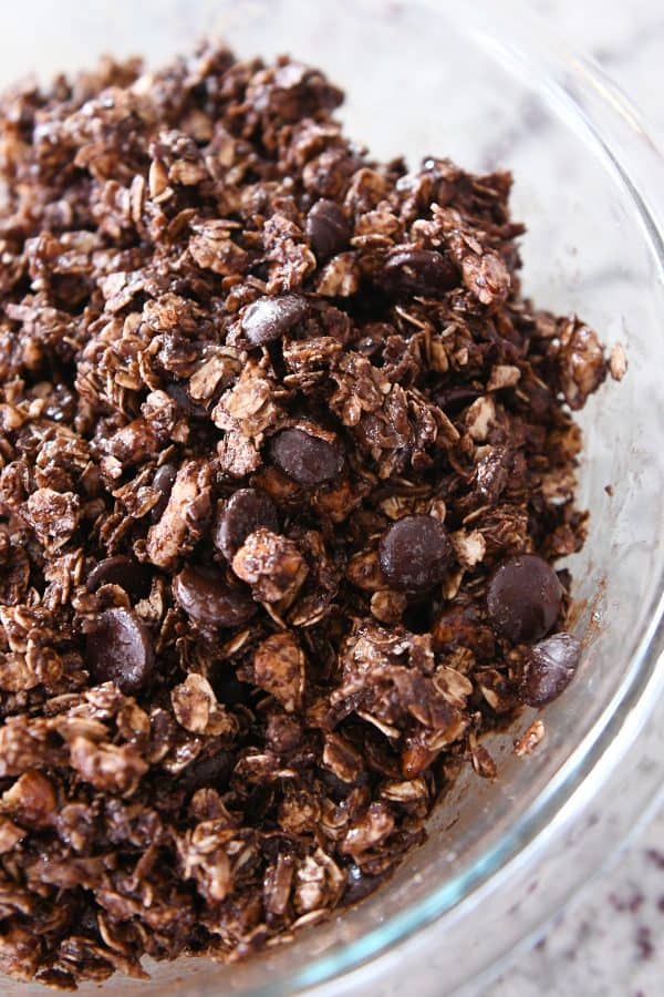 Chocolate chips mixed into dark chocolate brownie granola bar ingredients.