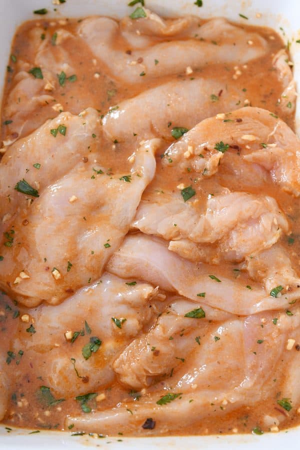 Raw chicken breasts in honey chipotle lime chicken marinade.