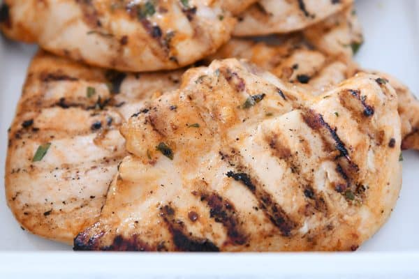 Grilled honey chipotle lime chicken in white dish.