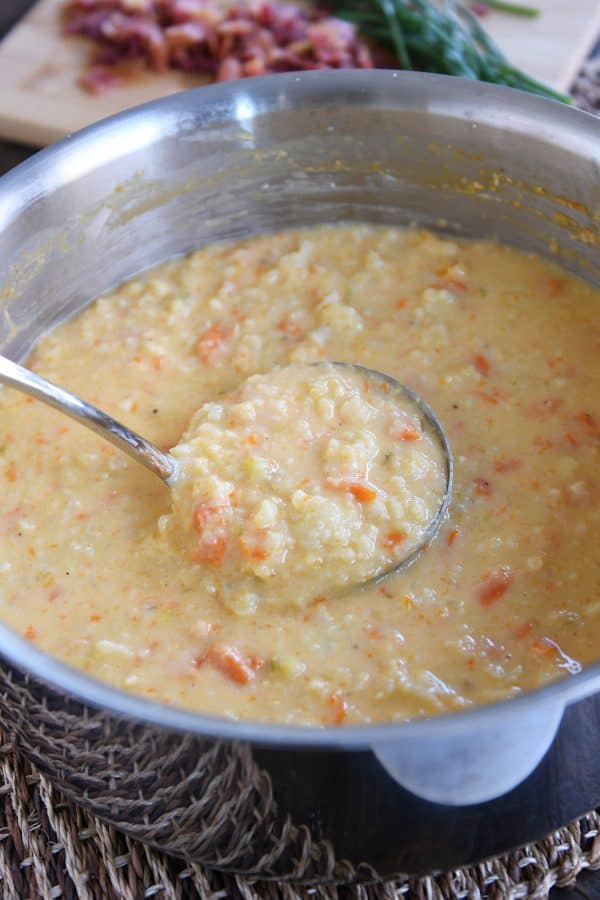 ladle in big pot of cheesy cauliflower soup