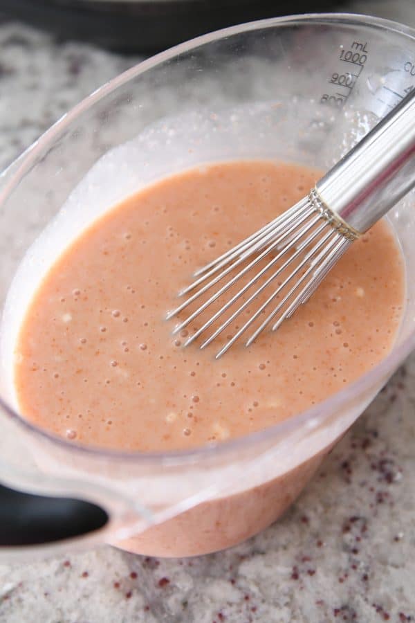 Whisking together coconut curry sauce for Instant Pot red curry noodles.