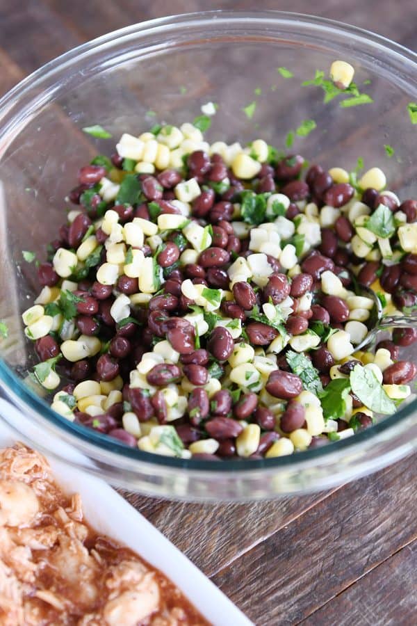 Corn and black bean salad in glass bowl.
