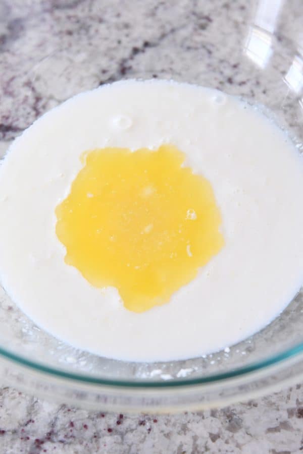 Adding butter to buttermilk for english muffin batter.