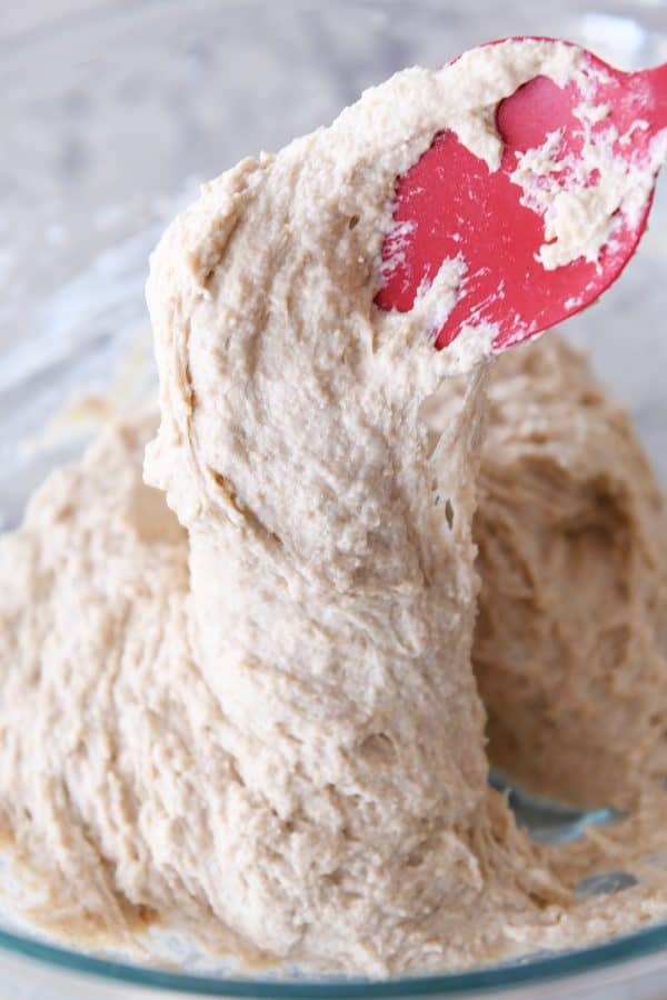 wet english muffin dough in glass bowl