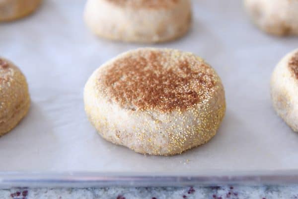 Baked english muffin on parchment lined baking sheet.