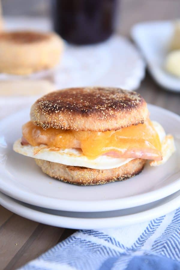 Homemade english muffins sandwiched with ham and egg.