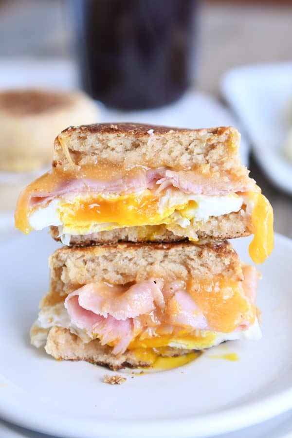 Homemade english muffins sandwiched with ham and egg.