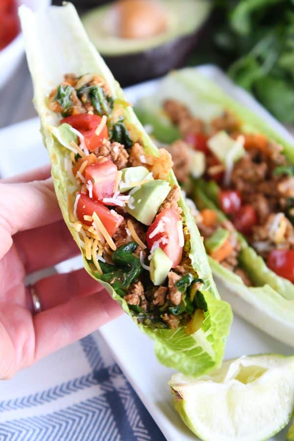 Holding veggie turkey taco lettuce cup.