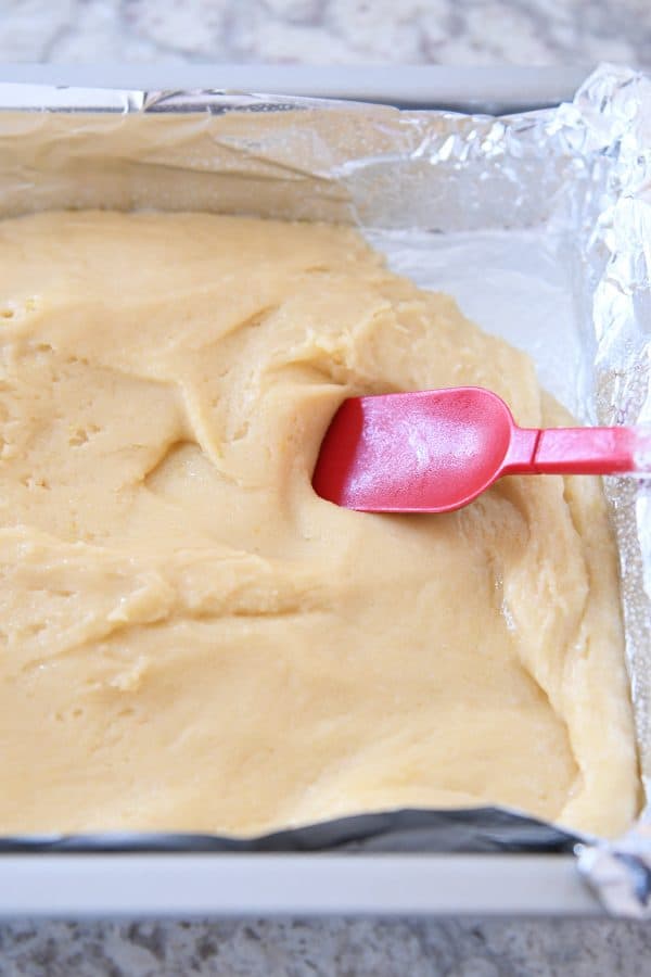 Spreading white chocolate brownie batter into 9X13-inch pan.