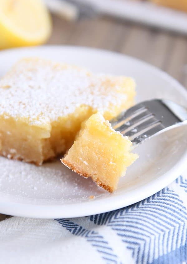 fork taking bite out of lemon bar white chocolate brownies