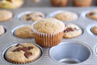 the best banana muffins in muffin tin with one muffin sitting on top