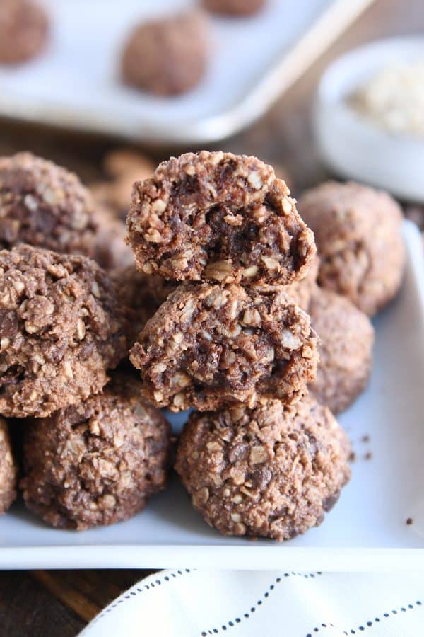 Stacks of chocolate peanut butter granola bites on white tray.