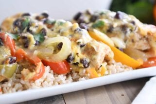 cheesy chicken enchilada bake over brown rice on white platter