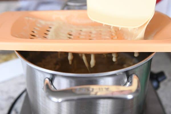 cooking homemade spaetzle in broth