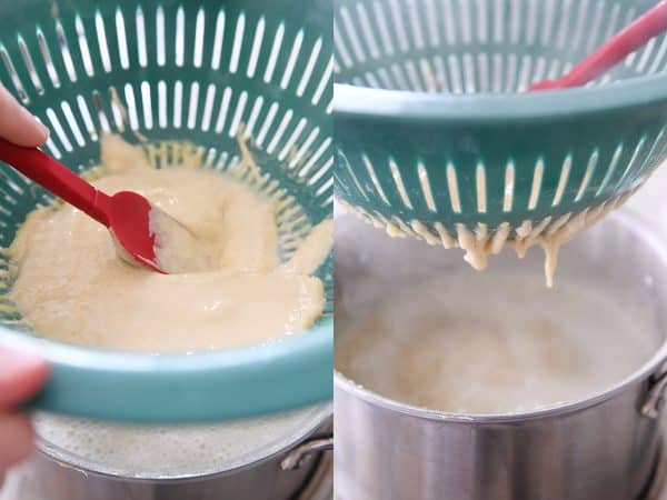 Using colander and spatula to make homemade spaetzle.