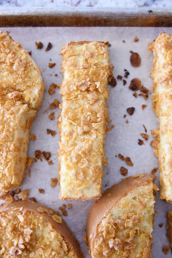 Crunchy baked french toast sticks on sheet pan after baking.