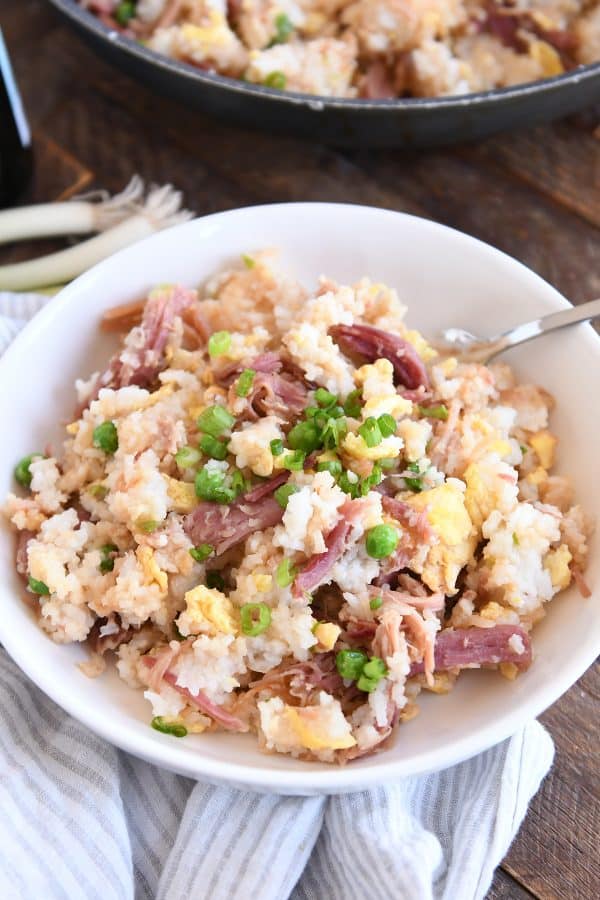 Easy ham fried rice in white bowl with spoon.