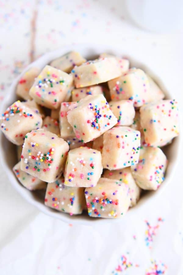 Top down view of baked funfetti shortbread bites in white bowl.