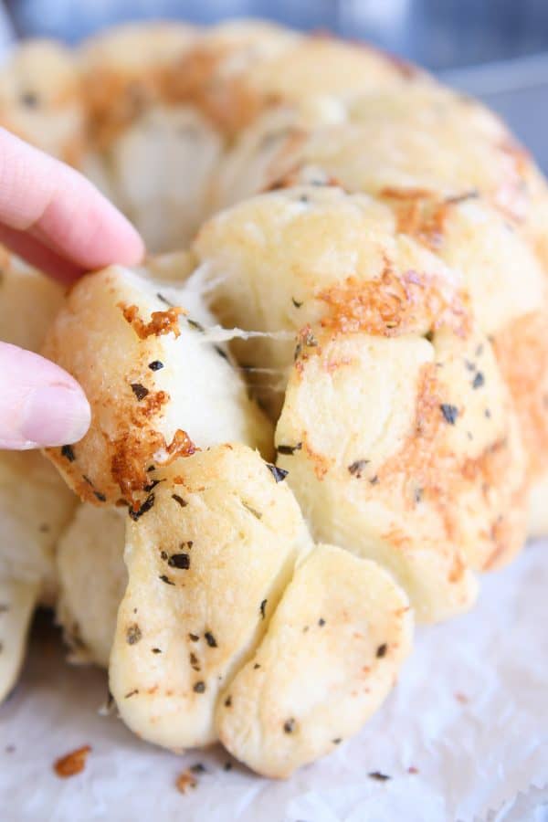 Pulling piece out of baked pull-apart bubble bread.