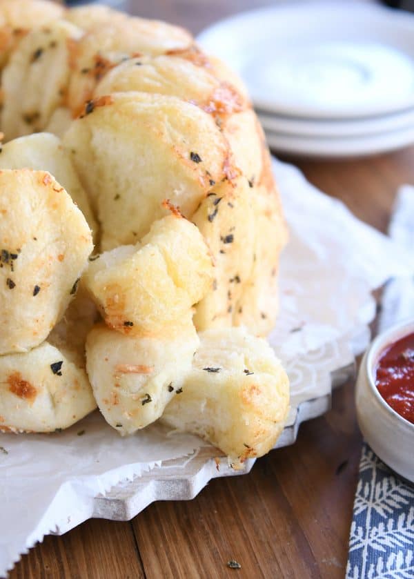 Buttery garlic + herb pull-apart bubble bread with pieces on the side.